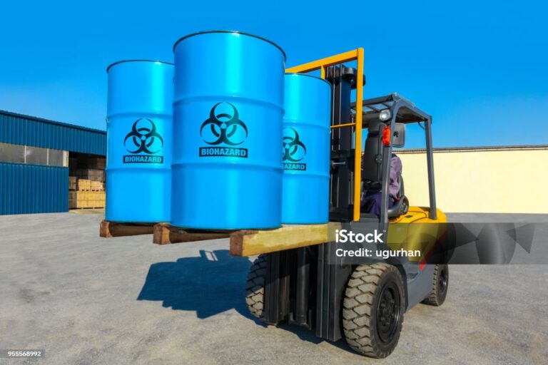 Blue barrels on forklift truck. Import export cargo concept